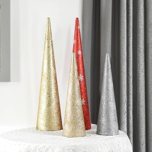 Close-up of glittery cone Christmas ornaments with white snowflake patterns in a set