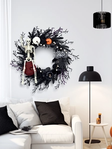 Detail of Halloween black twig wreath with mini pumpkins, skull and Happy Halloween sign