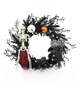 Halloween wreath with black branches, small pumpkins, skeleton, and Happy Halloween sign