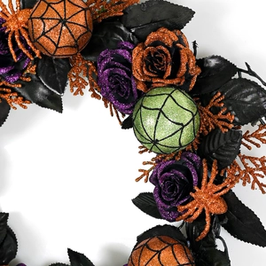 Halloween wreath with black leaves, orange spiders and glitter roses on white background