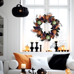 Halloween wreath with orange branches, glitter ornaments, and black leaves on white background