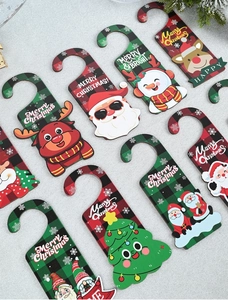 Flat lay of colorful Christmas wooden hanging tags featuring Santa Claus and Reindeer designs