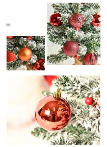 Detail of red and gold Christmas ornaments with embossed textures hanging on snow-flocked tree