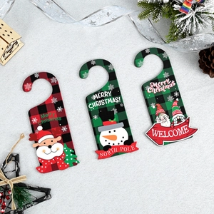 Close-up of Christmas wooden door hangers with reindeer, snowman and Santa motifs
