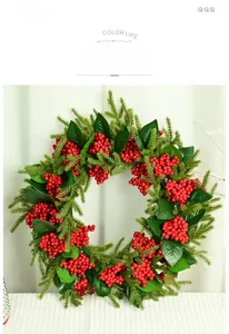 Macro detail of artificial Christmas wreath with red berries and green pine needles