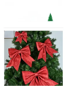 Detail of red glitter Christmas bows for tree decoration showing sparkling texture