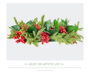 Close-up of artificial red berry wreath with festive green pine leaves on white backdrop