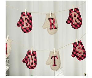 Detail of burlap Christmas mitten banner with red plaid fabric and wooden clips