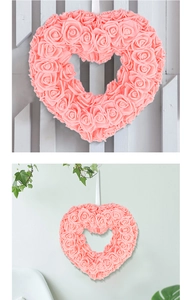 Close-up of pink rose heart wreath with hanging rope for wedding and Valentine decor