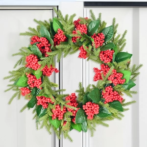 Christmas wreath with red berries and evergreen leaves for front door home decoration