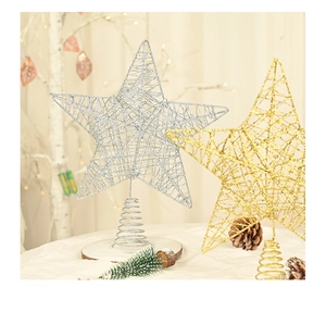Close-up of gold and silver iron Christmas tree toppers with glitter and spiral bases