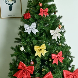 Glittery Christmas tree bow ornaments in gold and red for festive holiday decorations