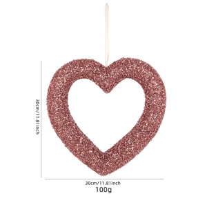 Pink glittery heart wreath for Valentine's Day party decor with white ribbon hanger