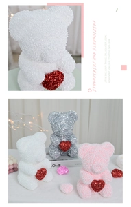 Detailed view of glitter-covered foam rose bears with red hearts for romantic gifts