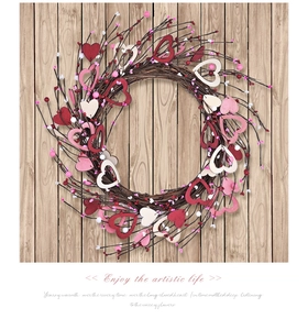Detail of a handmade heart-shaped wreath with wooden ornaments on a light wood background
