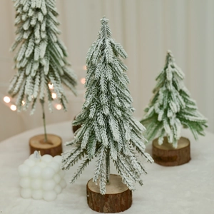 Set of three mini pine Christmas trees with snow flocking and natural wooden bases