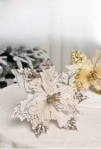 Macro detail of creamy velvet Christmas flower with sparkling gold sequins and embroidery