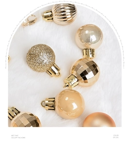 Close-up of champagne gold Christmas balls with diverse textures on a soft white plush rug