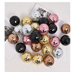 Close-up of colorful disco mirror balls in gold, silver, and pink for party decorations