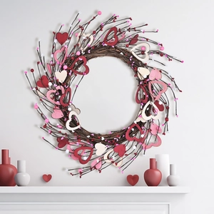Valentine heart wreath with red and pink wooden hearts on rustic twig base