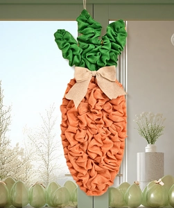 Detail of carrot-shaped Easter wreath made of orange burlap fabric with a beige bow tie