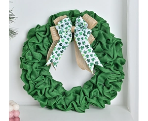 Close-up of Saint Patrick's Day green burlap wreath with shamrock ribbon bow detail