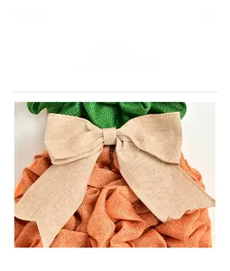 Macro shot of carrot-shaped wreath mesh texture and decorative burlap ribbon bow