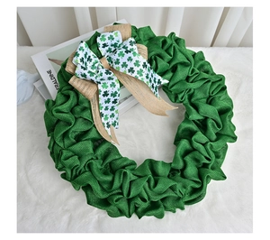Detailed view of Saint Patrick's Day burlap wreath with green shamrock pattern bow