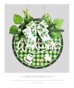 Close-up of St. Patrick's Day welcome wreath with green clover and striped bow detail