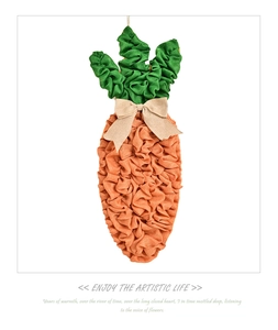 Detail of fabric carrot Easter decor featuring cotton linen texture and beige bow ornament