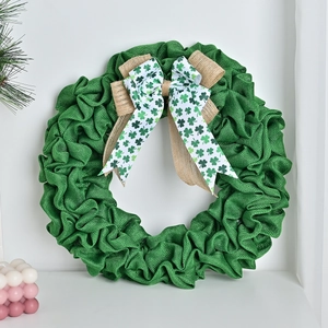 Round green burlap St. Patrick's Day wreath with clover pattern bow for door hanging