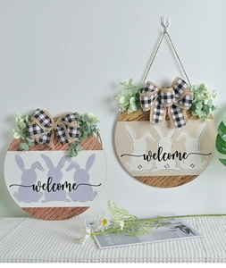 Detail of wooden Easter welcome sign with bunny silhouettes and buffalo plaid bow decoration