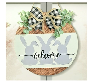 Detail of wooden Easter welcome sign with gray bunnies and black white plaid bow