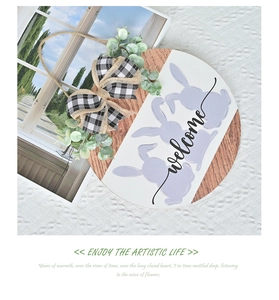 Detail of wooden Easter welcome sign with purple bunny, plaid bow and eucalyptus leaves