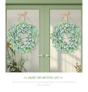 Symmetric rustic lamb's ear wreaths with burlap bows on a wooden double door