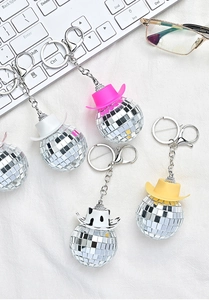 Close-up of disco ball cowboy hat keychains in various colors with metallic horseshoe hooks