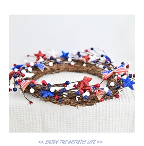 Detail of Fourth of July wreath with red white blue stars and berries on rattan base