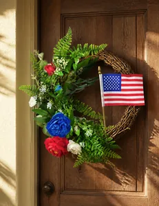 Close-up of American flag ornaments and blue flowers on Independence Day wreath
