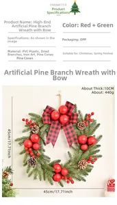 Detail of Christmas wreath with red berries, pine needles, and a red-black checkered bow