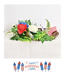 Detail of USA Independence Day wreath featuring red blue white flowers and US flags