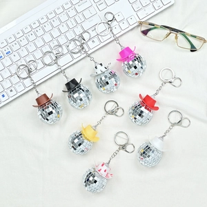 Disco ball cowboy hat keychains set in various colors including cow print and metallic tones