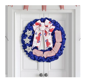 Detail of USA Independence Day wreath with blue burlap, stars and a red truck bow