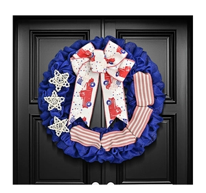 Close-up of patriotic door wreath with blue mesh, white stars and vintage truck ribbon