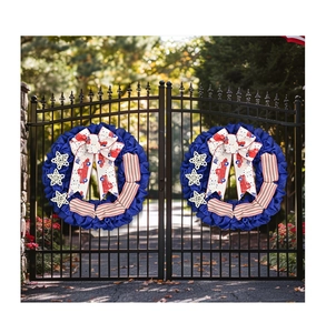 Close-up of July 4th door wreaths with red truck bows and stars on black gates