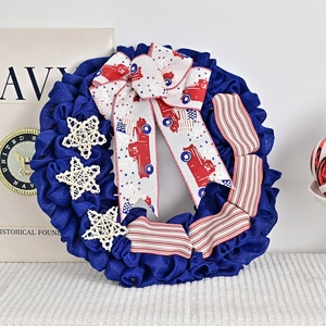 Patriotic wreath with white stars and vintage red truck bow for Independence Day door decor