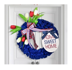 Detail of USA patriotic wreath with tulips and a Home Sweet Home sign on a white door