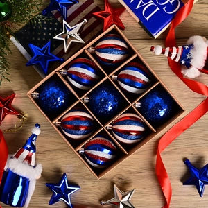 9-piece set of red, white, and blue American flag style Christmas ball ornaments in box