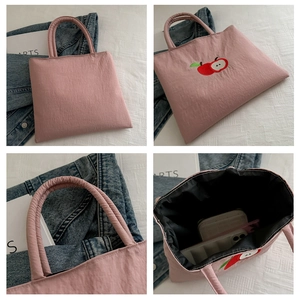 Pink nylon tote with apple embroidery showing front, back, and internal storage details