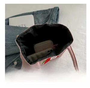 Internal view of pink tote bag showing spacious capacity for phone and wallet