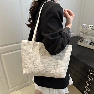 Large cream woven straw tote bag with leather straps for summer beach or casual outdoor use